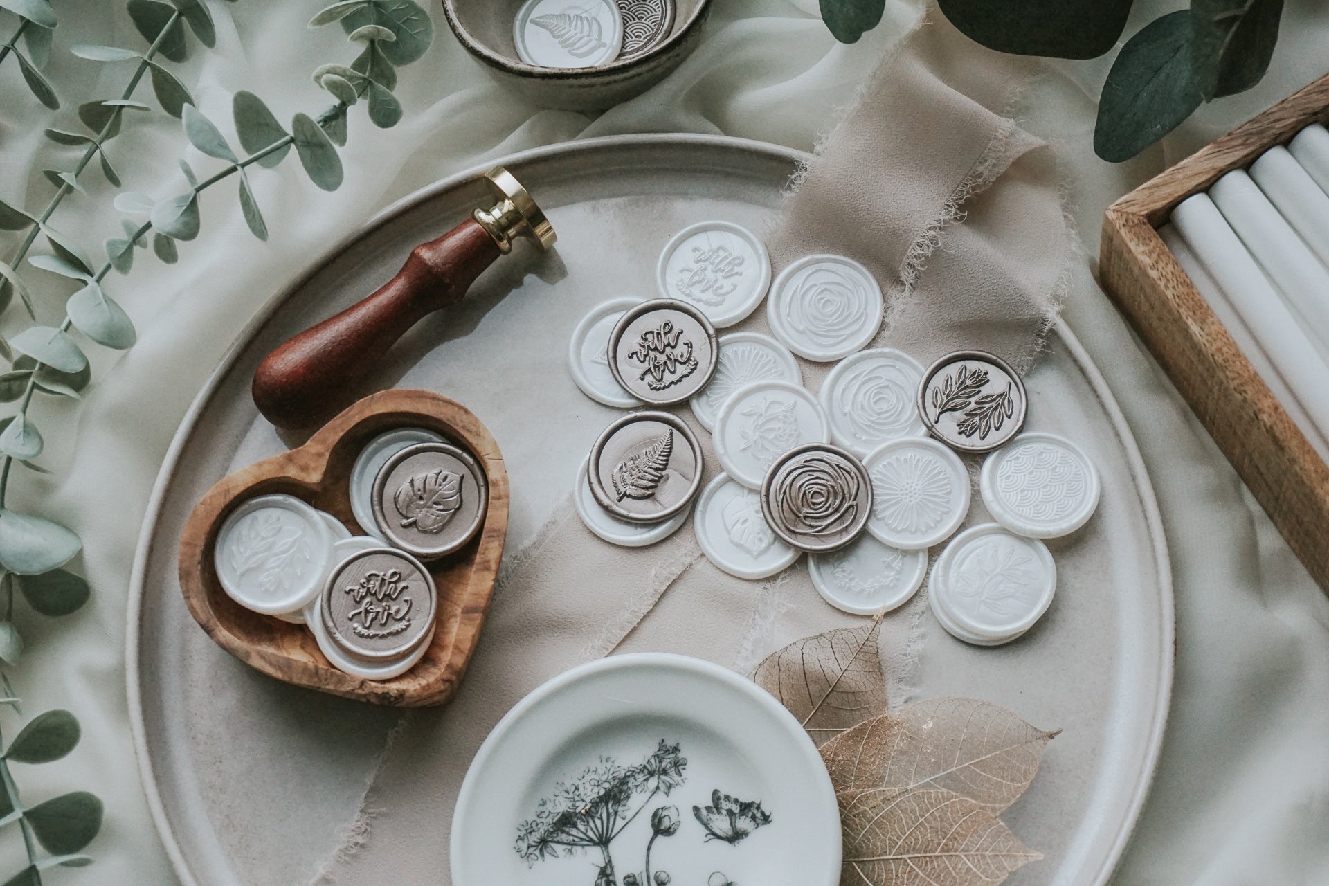 multiple_designs-wax_seals_in_bowl_and_laid_out-Dove_white-Antique_gold-floral-botanical-background - Made of Honour Co.16184552193b4706ec-0