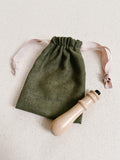 green suede bag with made of honour co logo embossed