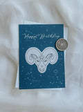 Aries greeting card in Aquamarine colour with antique gold wax seal and envelope in the background.