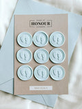 baby feet set of 9 wax seals in Baby blue colour with paper backing in the background.